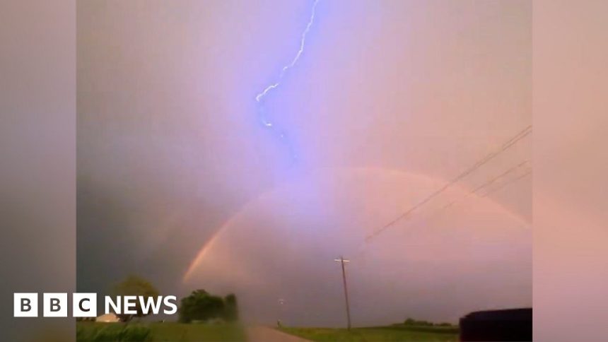 Driver captures lightning over a rainbow in Iowa