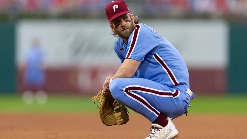 Phillies standout Bryce Harper (back) out of lineup vs. Twins